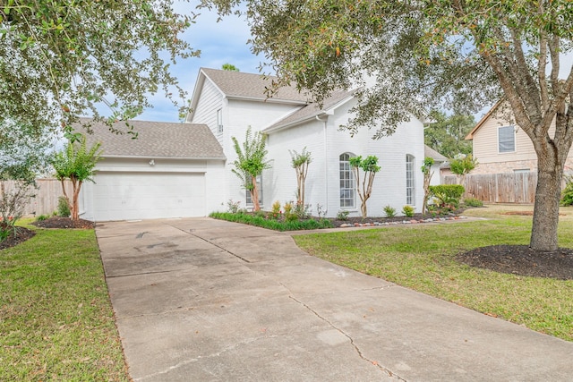 view of front of property with a front yard and a garage