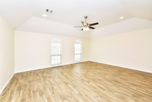 empty room featuring ceiling fan, light hardwood / wood-style floors, and lofted ceiling