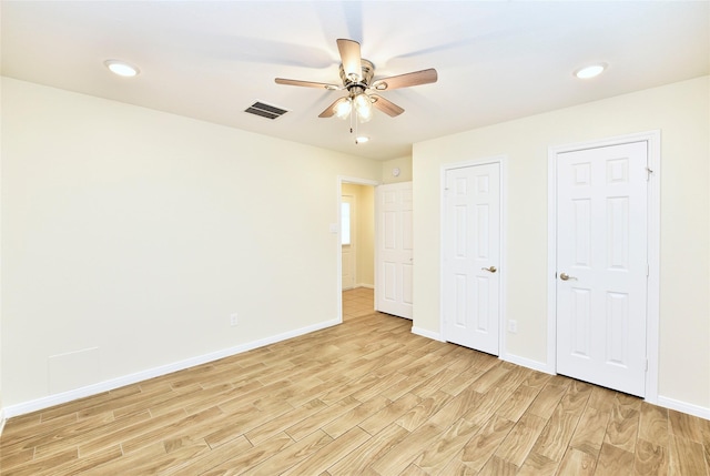 unfurnished bedroom with ceiling fan and light hardwood / wood-style flooring