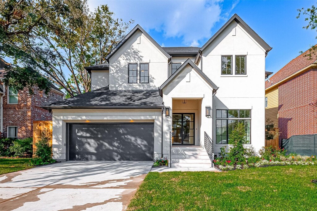view of front of property featuring a front lawn and a garage