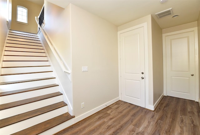 stairway with hardwood / wood-style floors