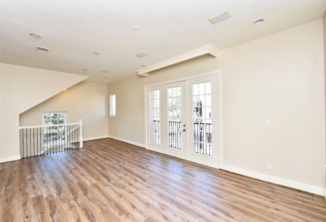 empty room featuring light wood-type flooring and french doors