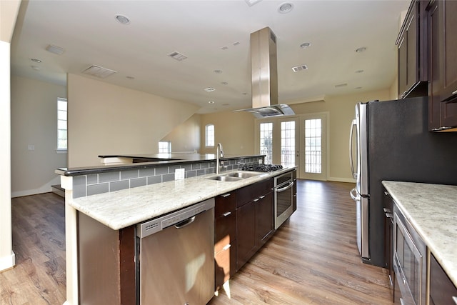 kitchen featuring light hardwood / wood-style flooring, stainless steel appliances, dark brown cabinetry, island range hood, and sink