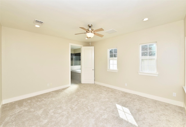 carpeted empty room featuring ceiling fan