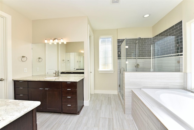 bathroom with separate shower and tub and vanity