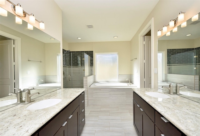 bathroom featuring separate shower and tub and vanity