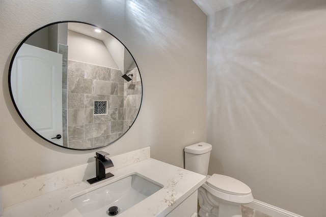 bathroom featuring toilet and vanity