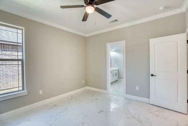 interior space with ceiling fan, ornamental molding, and ensuite bath