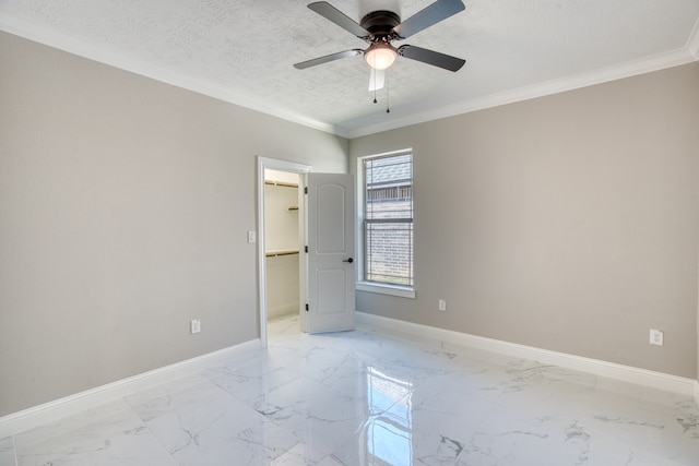 spare room with a textured ceiling, ornamental molding, and ceiling fan