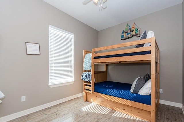 bedroom with ceiling fan and hardwood / wood-style floors