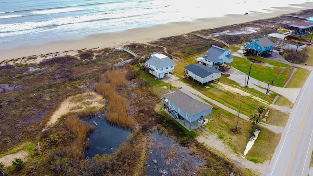 aerial view with a water view and a view of the beach