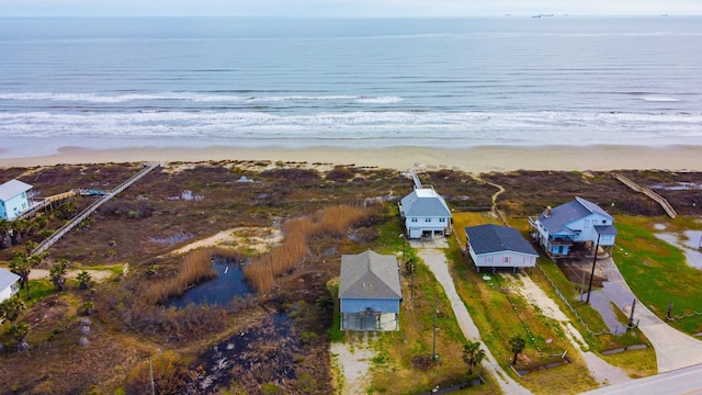 drone / aerial view with a beach view and a water view