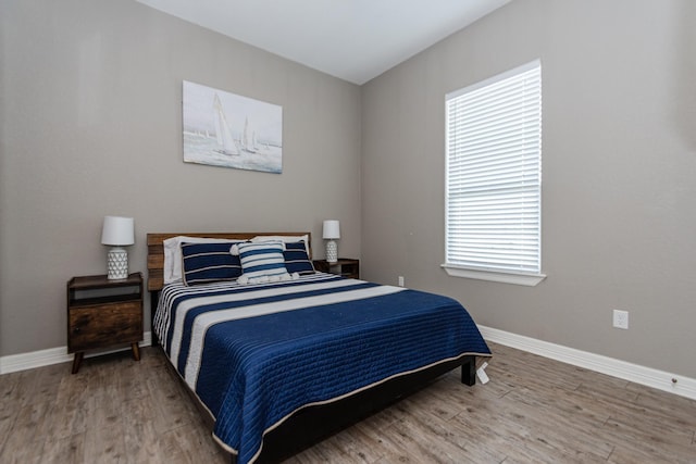 bedroom with hardwood / wood-style floors