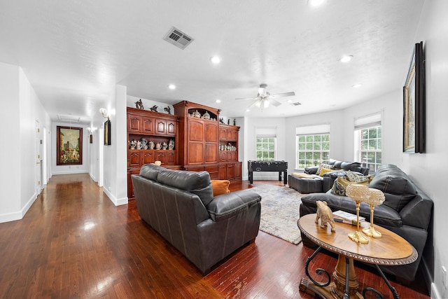 living room featuring baseboards, visible vents, a ceiling fan, dark wood-type flooring, and recessed lighting