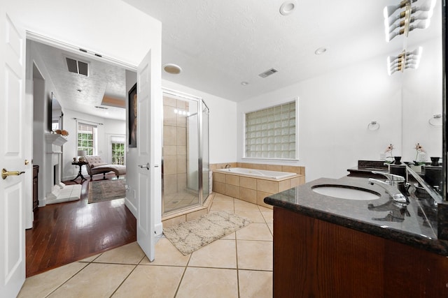 full bathroom with a bath, a shower stall, visible vents, and tile patterned floors