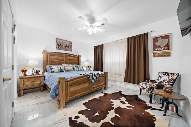 bedroom with marble finish floor and a ceiling fan