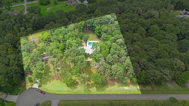 bird's eye view featuring a wooded view