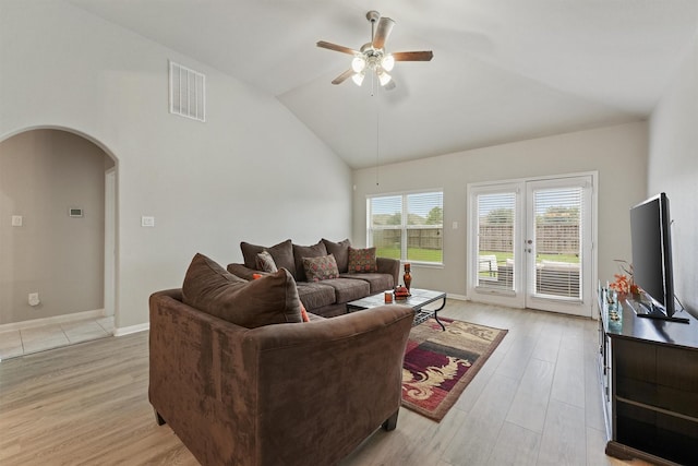 living room featuring lofted ceiling, ceiling fan, and light hardwood / wood-style flooring