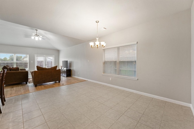 living room with vaulted ceiling and ceiling fan with notable chandelier