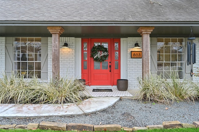 view of exterior entry featuring a porch