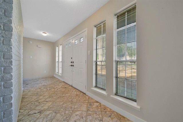 entryway featuring a wealth of natural light and baseboards