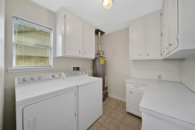 laundry area with washing machine and clothes dryer, baseboards, water heater, light tile patterned flooring, and cabinet space