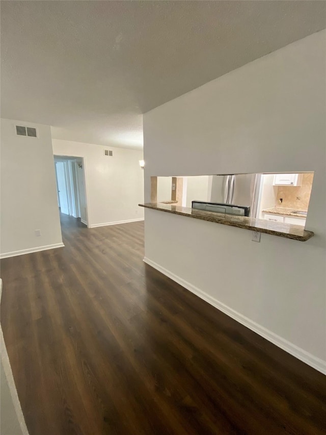 unfurnished living room featuring dark hardwood / wood-style floors