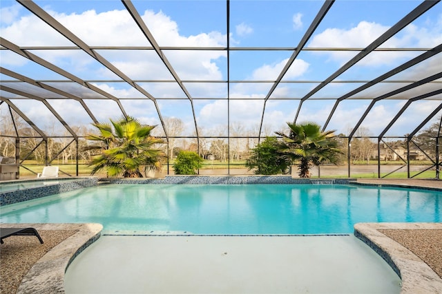 view of pool with a patio area and a lanai