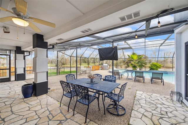 view of patio / terrace with ceiling fan and a lanai