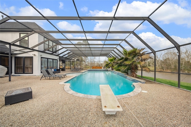 view of swimming pool featuring pool water feature, a patio, a lanai, and a diving board