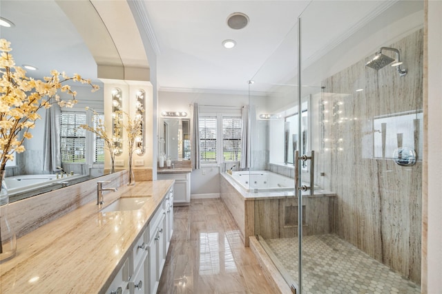 bathroom featuring ornamental molding, vanity, and shower with separate bathtub