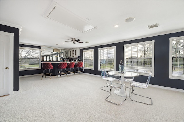 interior space with bar, plenty of natural light, and ornamental molding