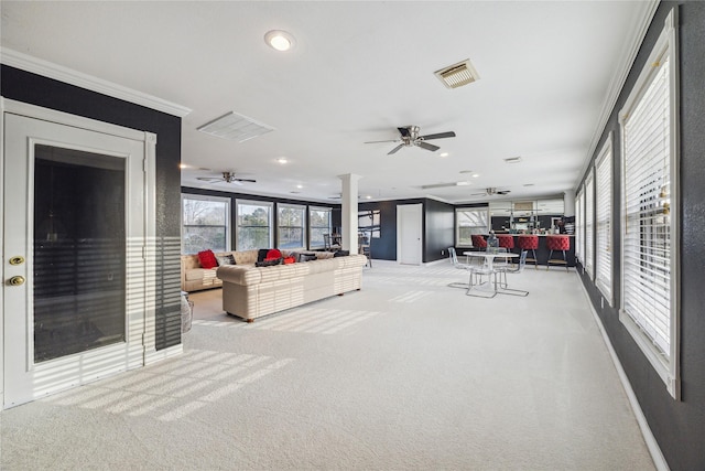 interior space with ceiling fan and ornamental molding