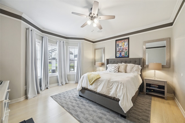 bedroom with ceiling fan, light hardwood / wood-style floors, and crown molding