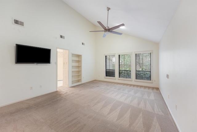 unfurnished living room with built in features, visible vents, light carpet, vaulted ceiling, and ceiling fan