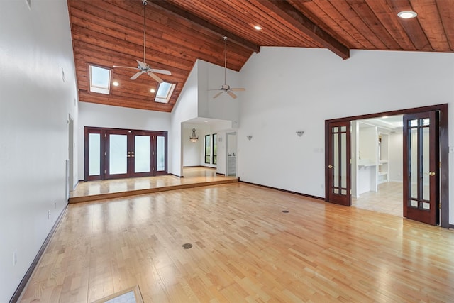 unfurnished living room with french doors, wooden ceiling, and light wood finished floors