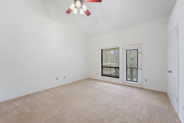 spare room with high vaulted ceiling, light colored carpet, and ceiling fan