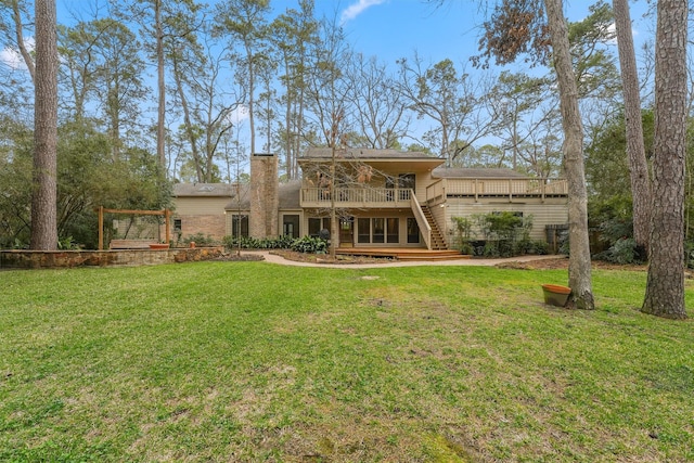 back of property with a lawn and a wooden deck