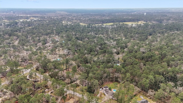 birds eye view of property featuring a view of trees