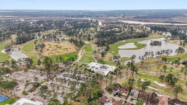 drone / aerial view with view of golf course and a water view