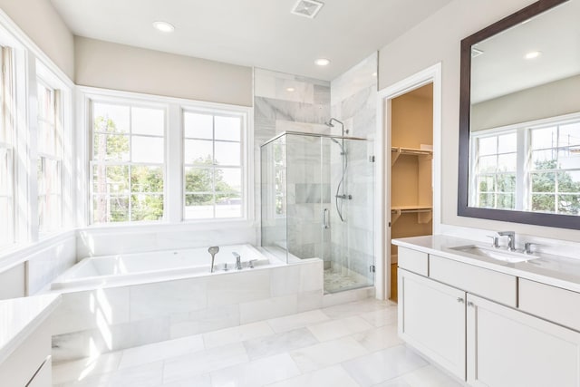 bathroom with separate shower and tub, vanity, and plenty of natural light