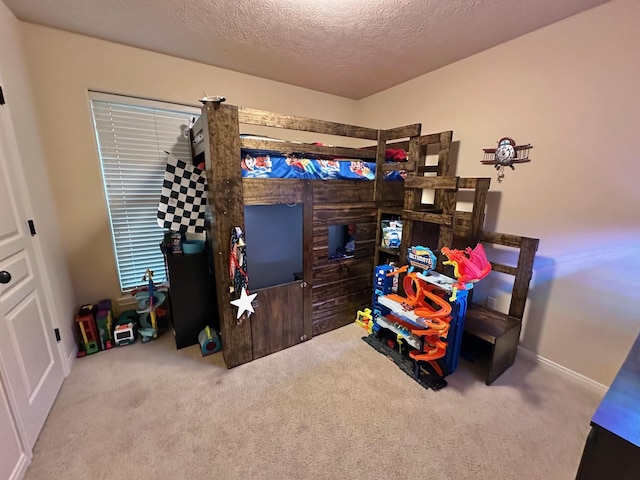 bedroom featuring carpet and a textured ceiling