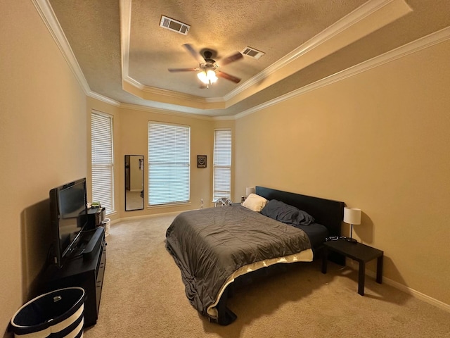 bedroom featuring ornamental molding, a raised ceiling, and carpet