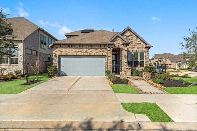 view of front of home featuring a garage, concrete driveway, brick siding, and roof with shingles