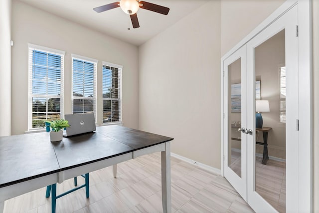 home office with baseboards, a ceiling fan, and french doors