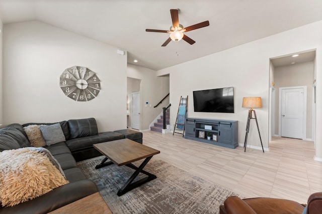 living room featuring lofted ceiling, ceiling fan, baseboards, and stairs