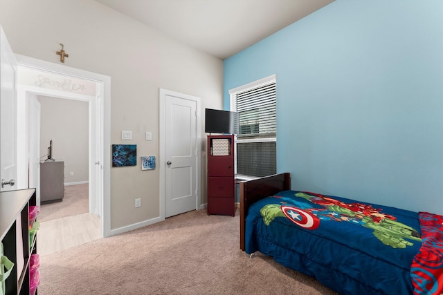 carpeted bedroom featuring baseboards