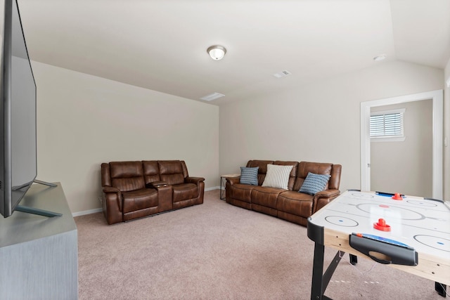 living area with lofted ceiling, light colored carpet, visible vents, and baseboards