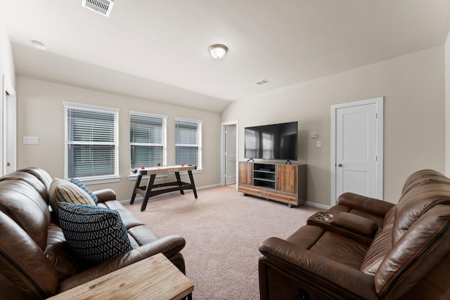 living area featuring visible vents, vaulted ceiling, light carpet, and baseboards