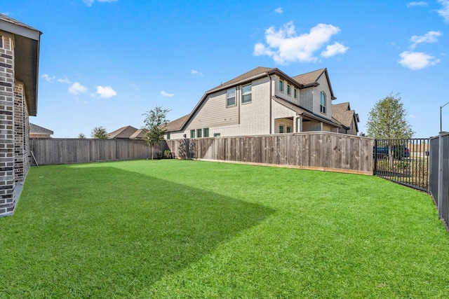 view of yard with a fenced backyard